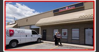 Harvey and Lisa in front of the Harvey White Auto Glass shop